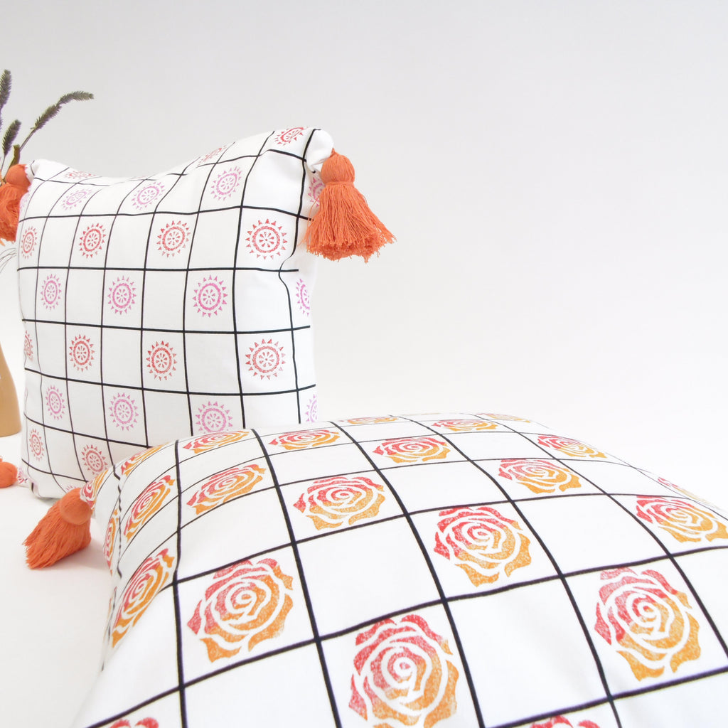 Decorative pillows with geometric patterns on a light background