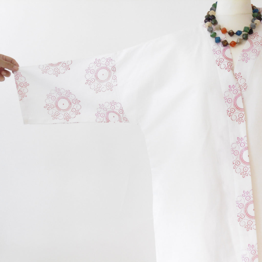 Close up of floral mandala hand block print on white linen kimono jacket