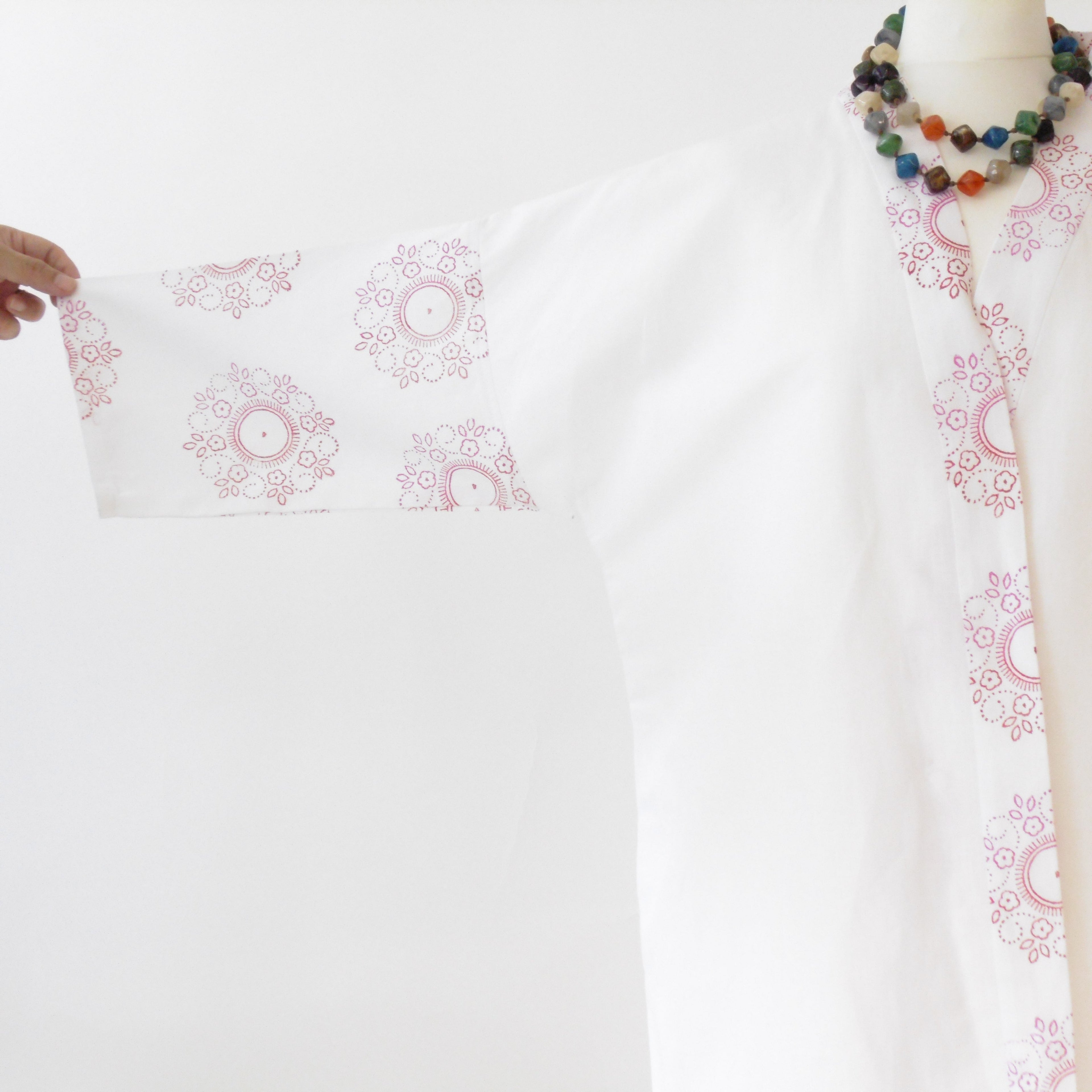 Close up of floral mandala hand block print on white linen kimono jacket