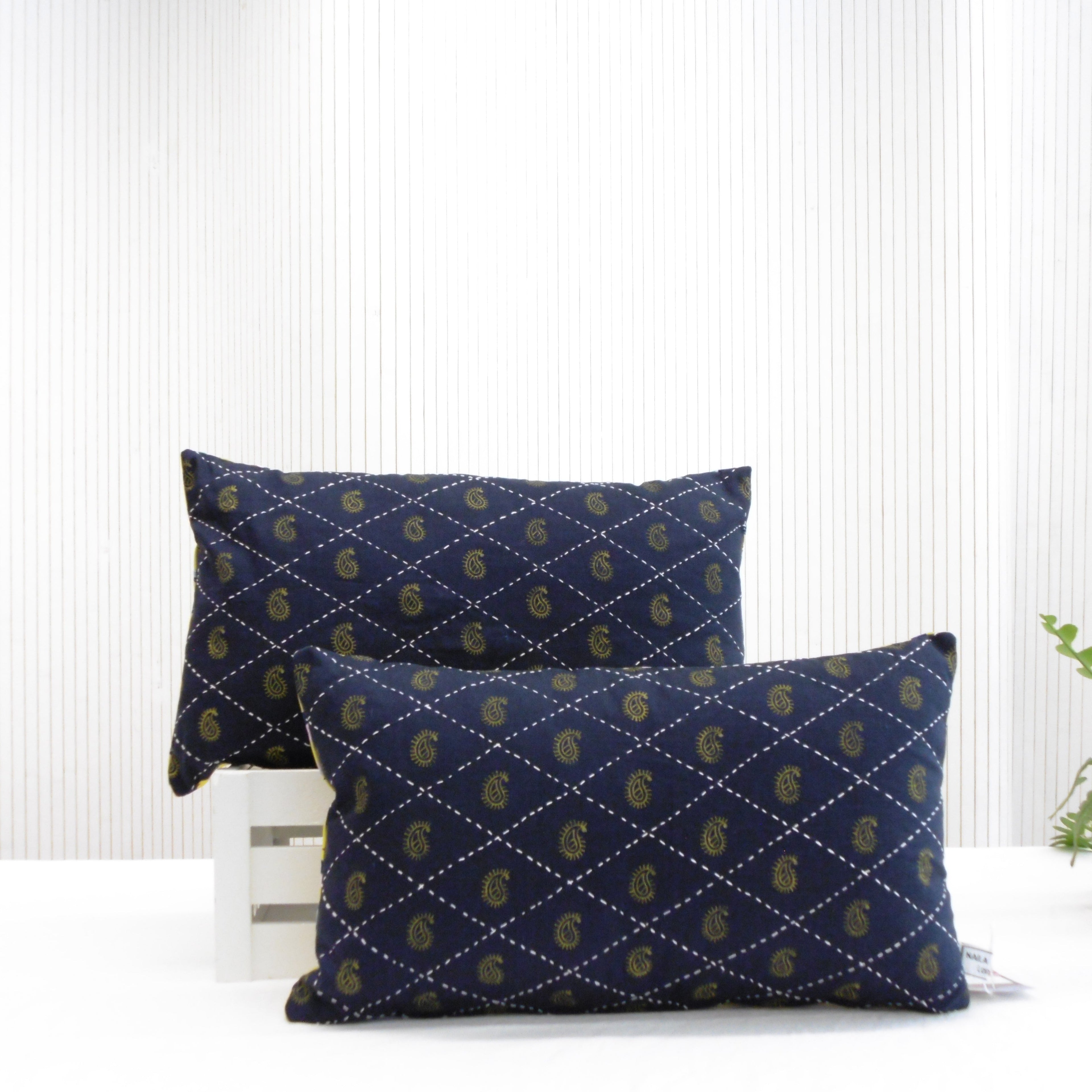Pair of hand block printed navy blue oblong cushions with paisley design and hand stitched diamond grid, Tanka by Naila Ahmad London