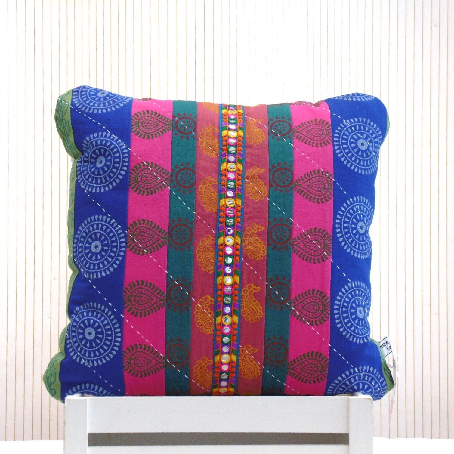 Hand block printed Mela Magic square cushion in blue pink and teal patchwork with mirror trim detail, colour coordinated front and back panels, by Naila Ahmad London