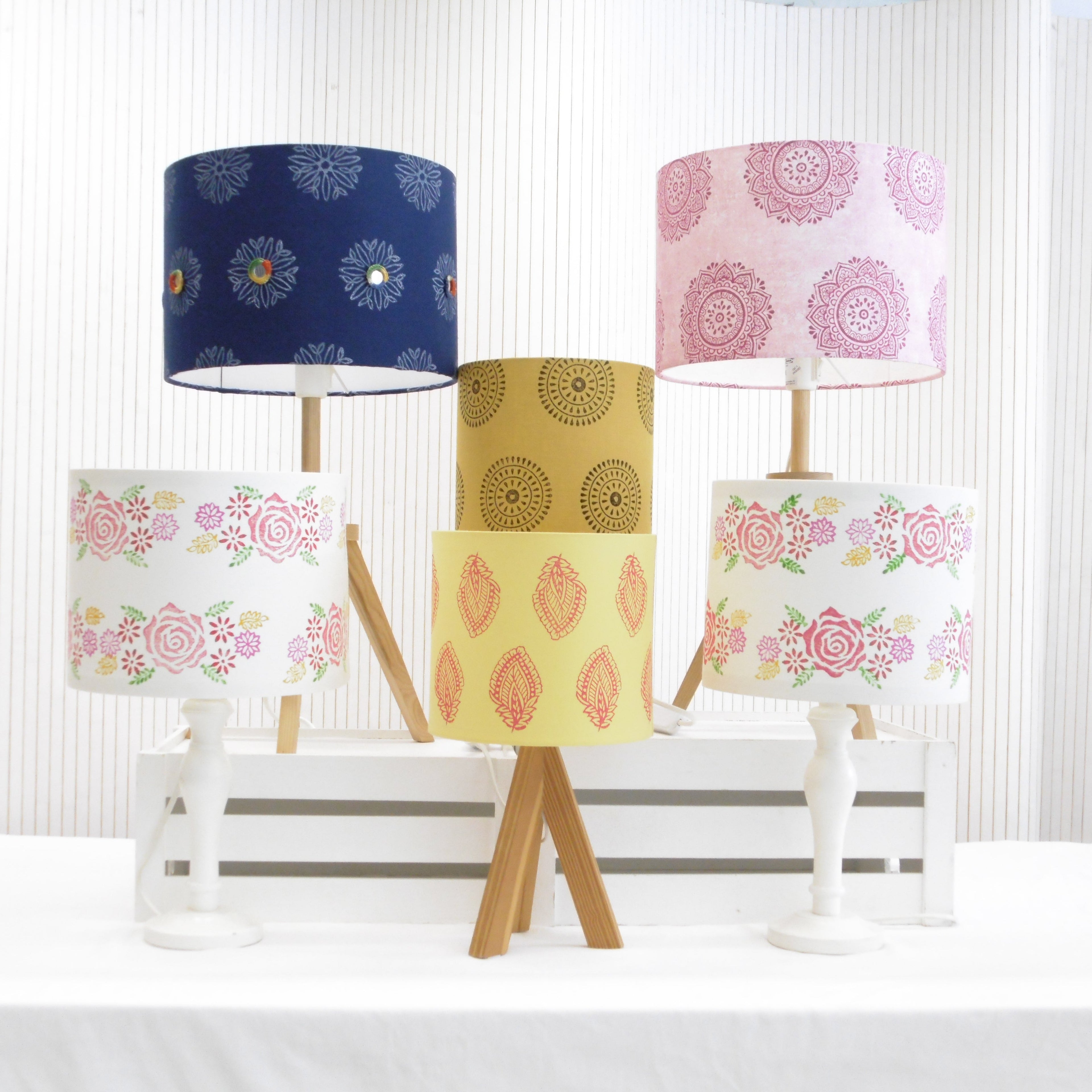 Collection of hand block printed lampshades in navy blue pink mustard and yellow with floral and geometric designs, made to order by Naila Ahmad London