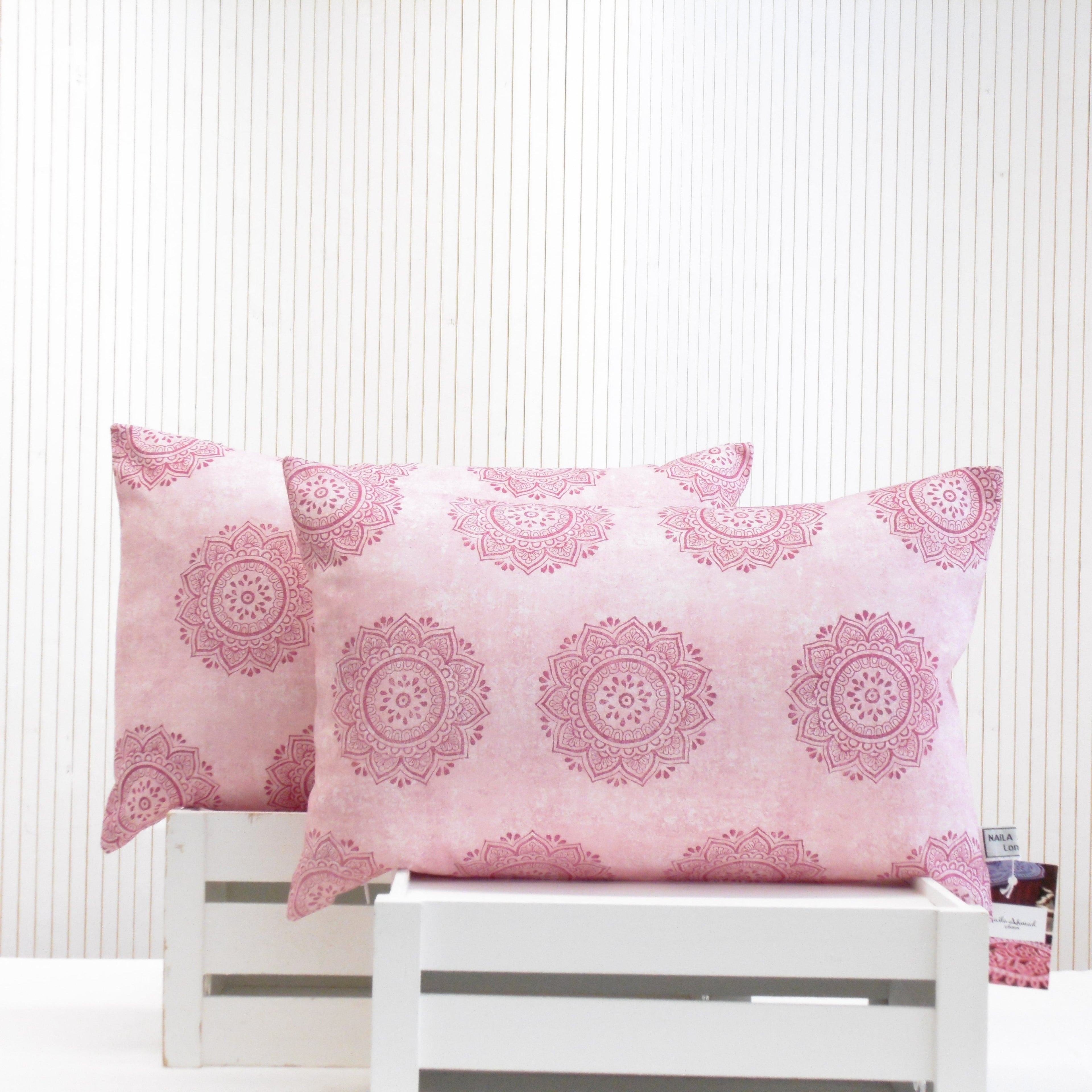 Pair of hand block printed pink mandala oblong cushions, part of the Gulabi Aangan home set by Naila Ahmad London