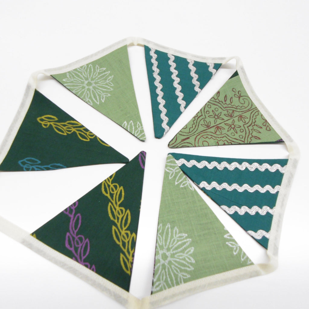 Handmade hand block printed green cotton and linen bunting with floral vine and silver ricrac flag garland