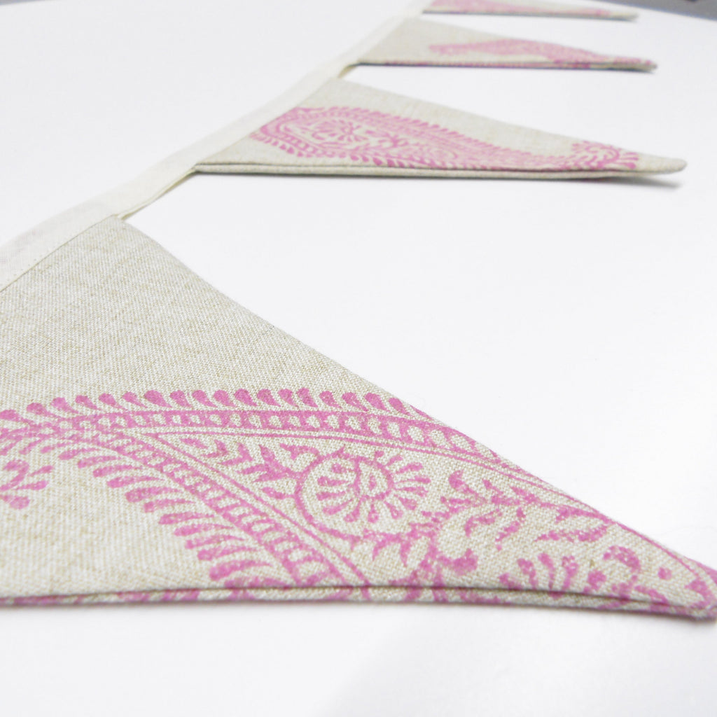 Side view of pink hand block printed linen bunting flags showing texture and paisley motif detail