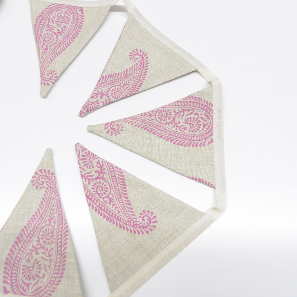 Pink paisley hand block printed linen bunting flags spread in a circle showing full design detail
