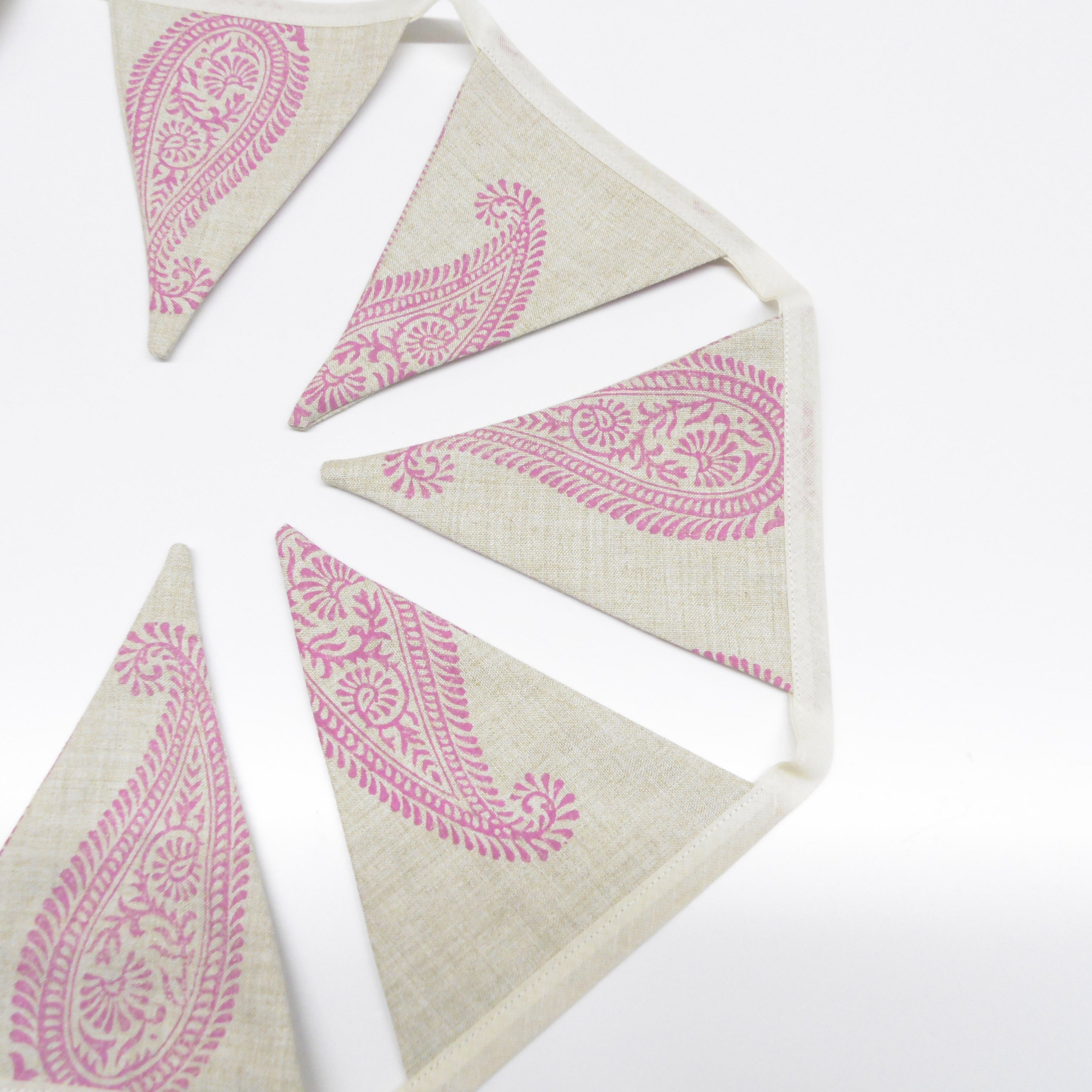 Pink paisley hand block printed linen bunting flags spread in a circle showing full design detail