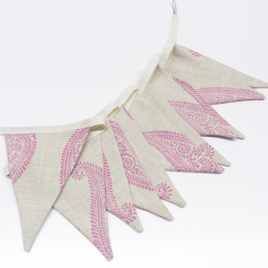 Handmade hand block printed pink paisley linen bunting flag garland fanned out on white background
