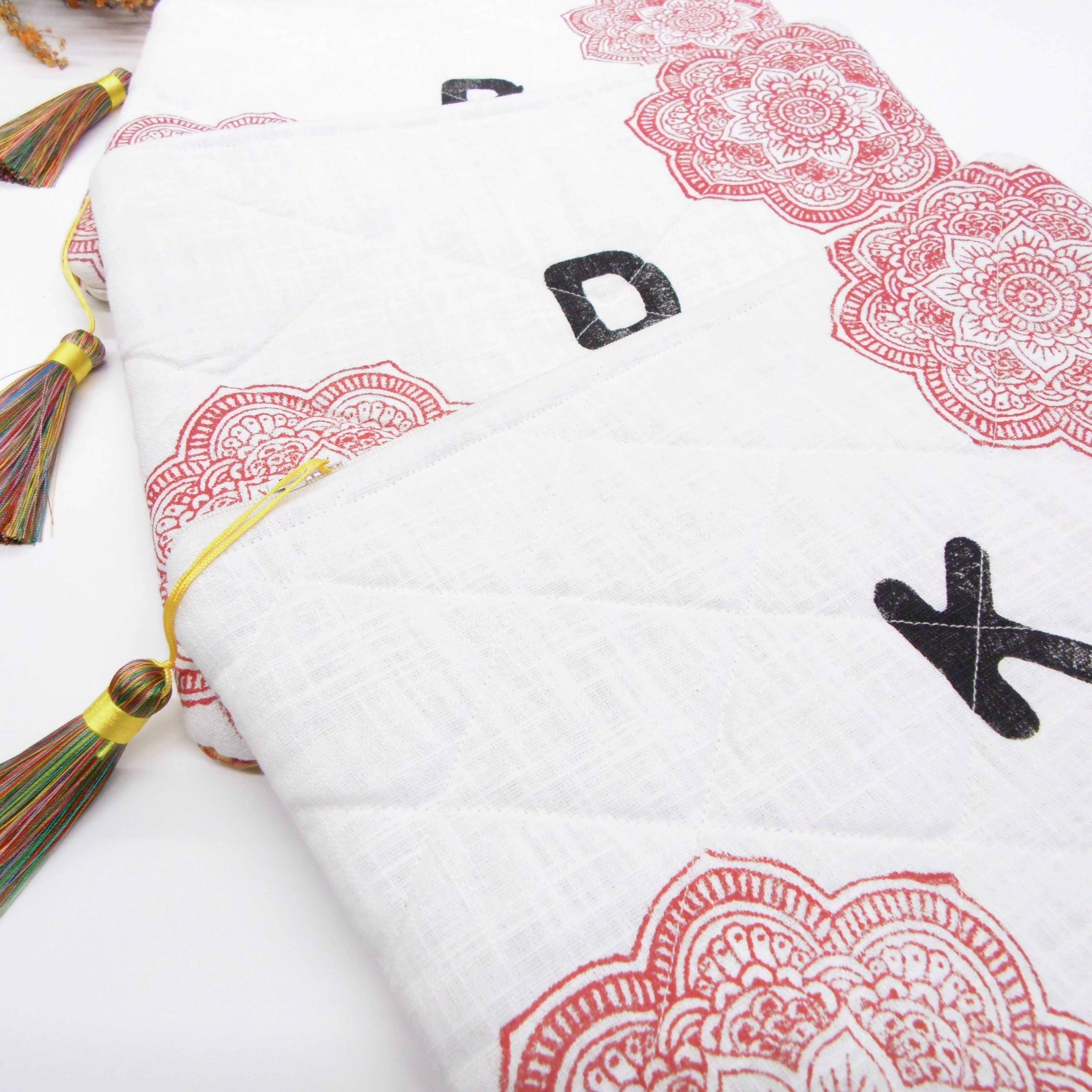 Quilted hand block printed pouch with red mandala print and letter F tassel