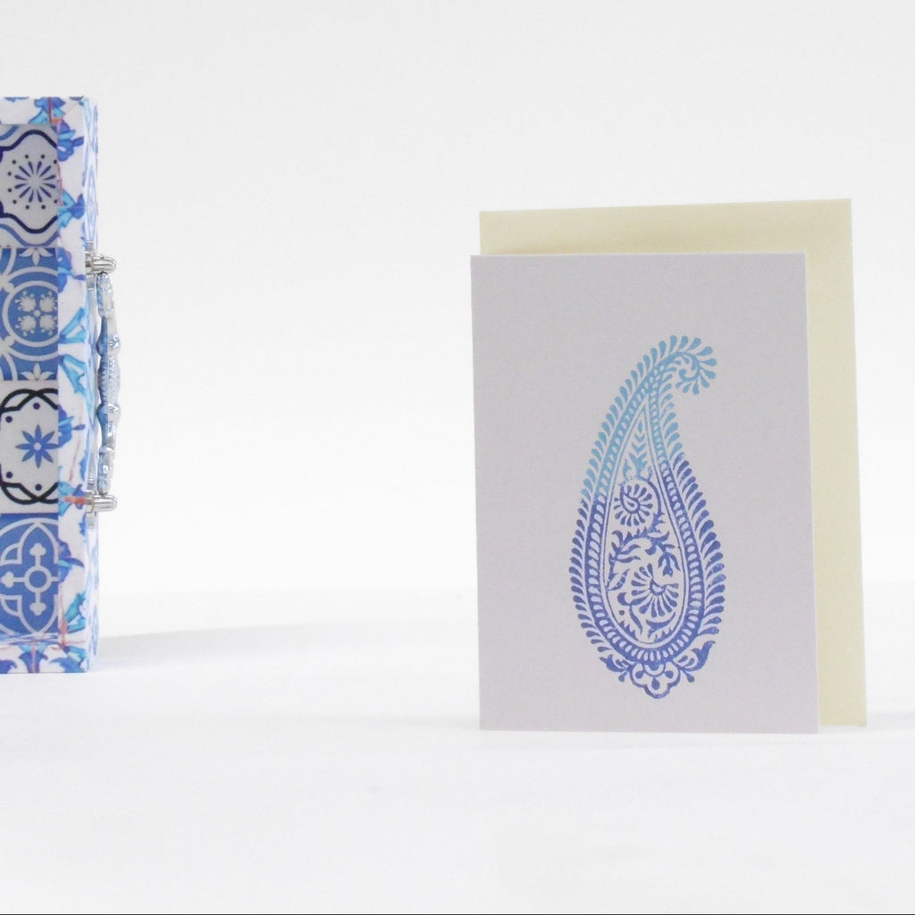 Greeting card with blue paisley design on a white background