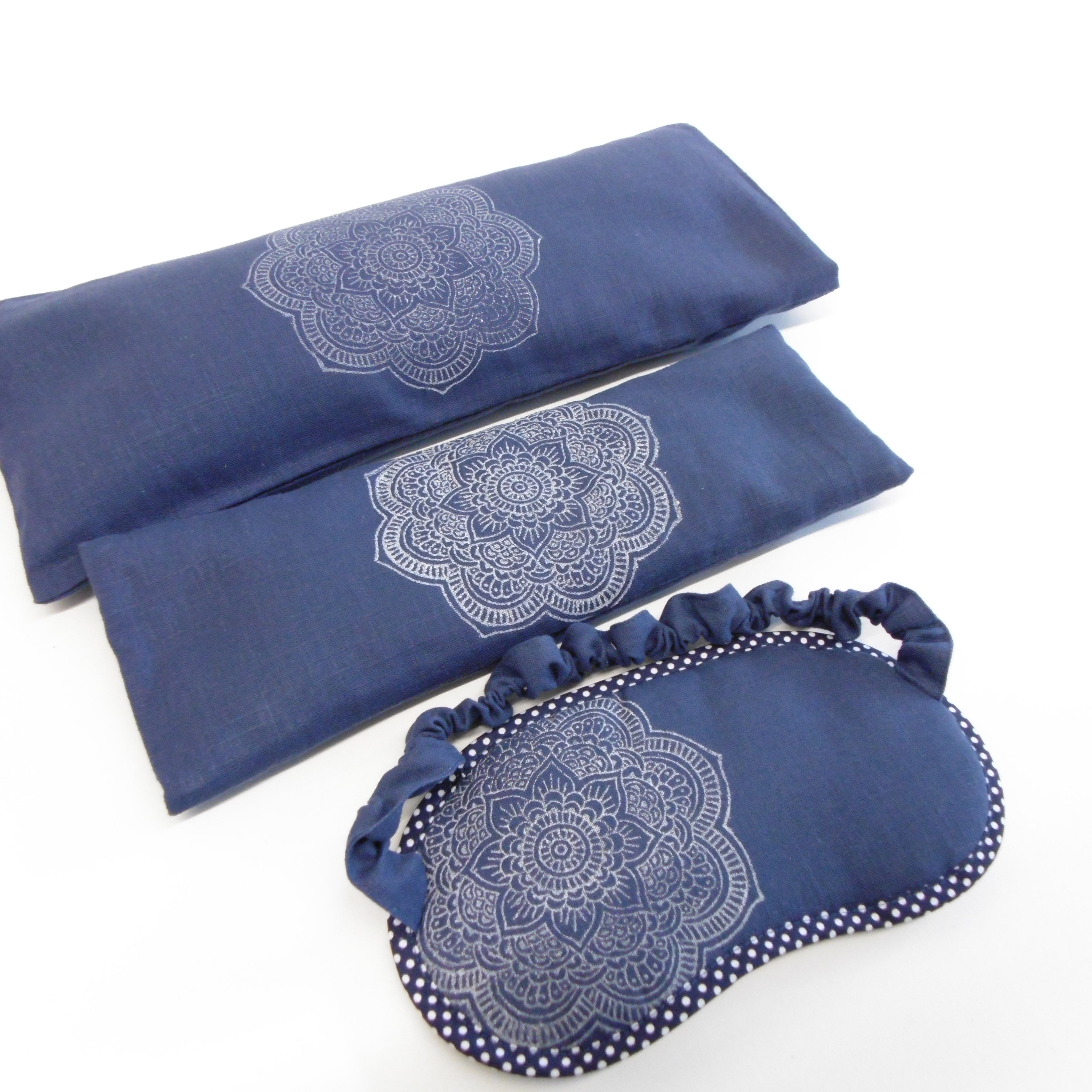 Set of blue eye pillows with mandala patterns on a white background