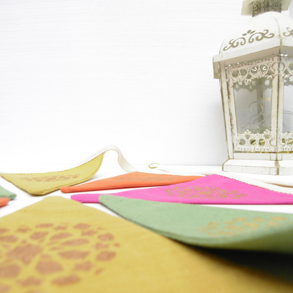 Colorful bunting with a decorative lantern on a white background