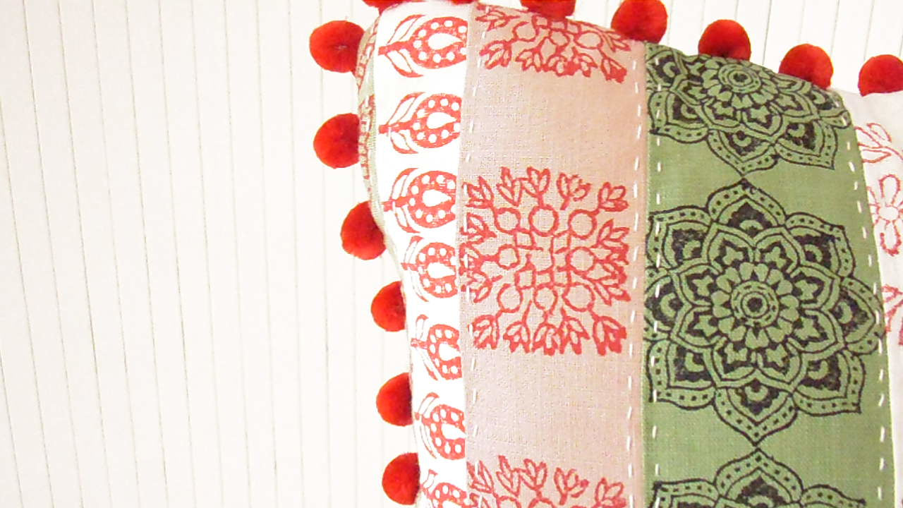 patchwork cushion hand printed in white red green and pink colors an dfabrics