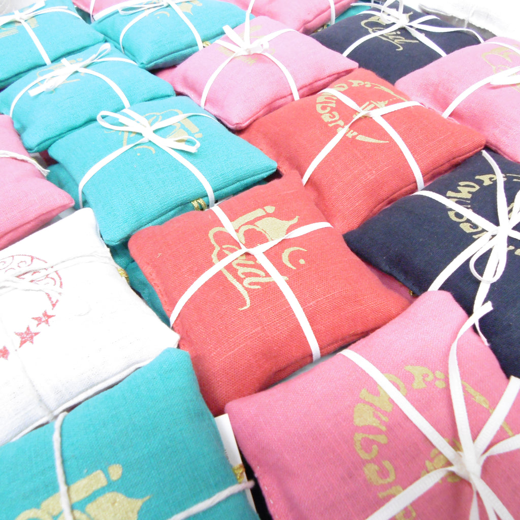 Colorful folded fabrics with decorative patterns and ribbons.