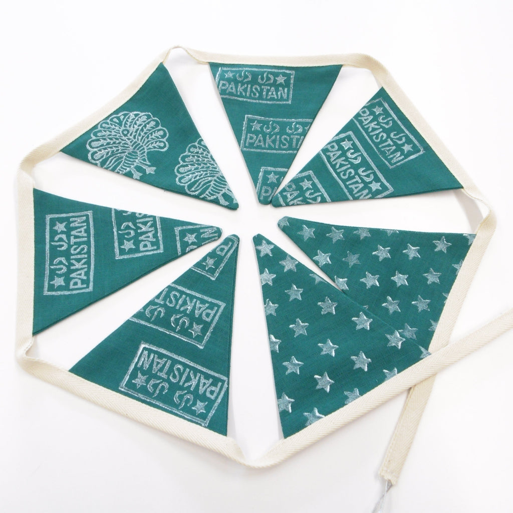 Hand block printed green linen bunting with Pakistan motifs including crescent moons, stars and peacocks