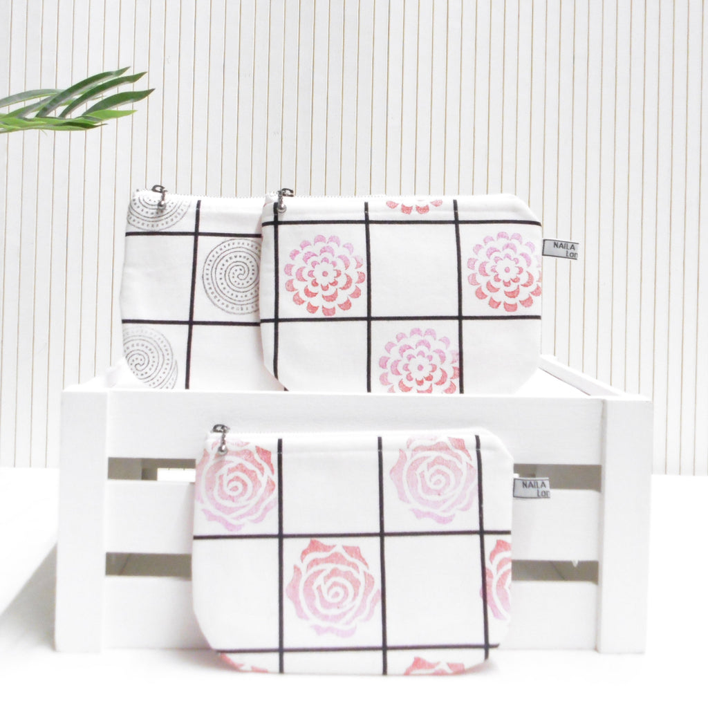 Two pouches with geometric patterns on a white background