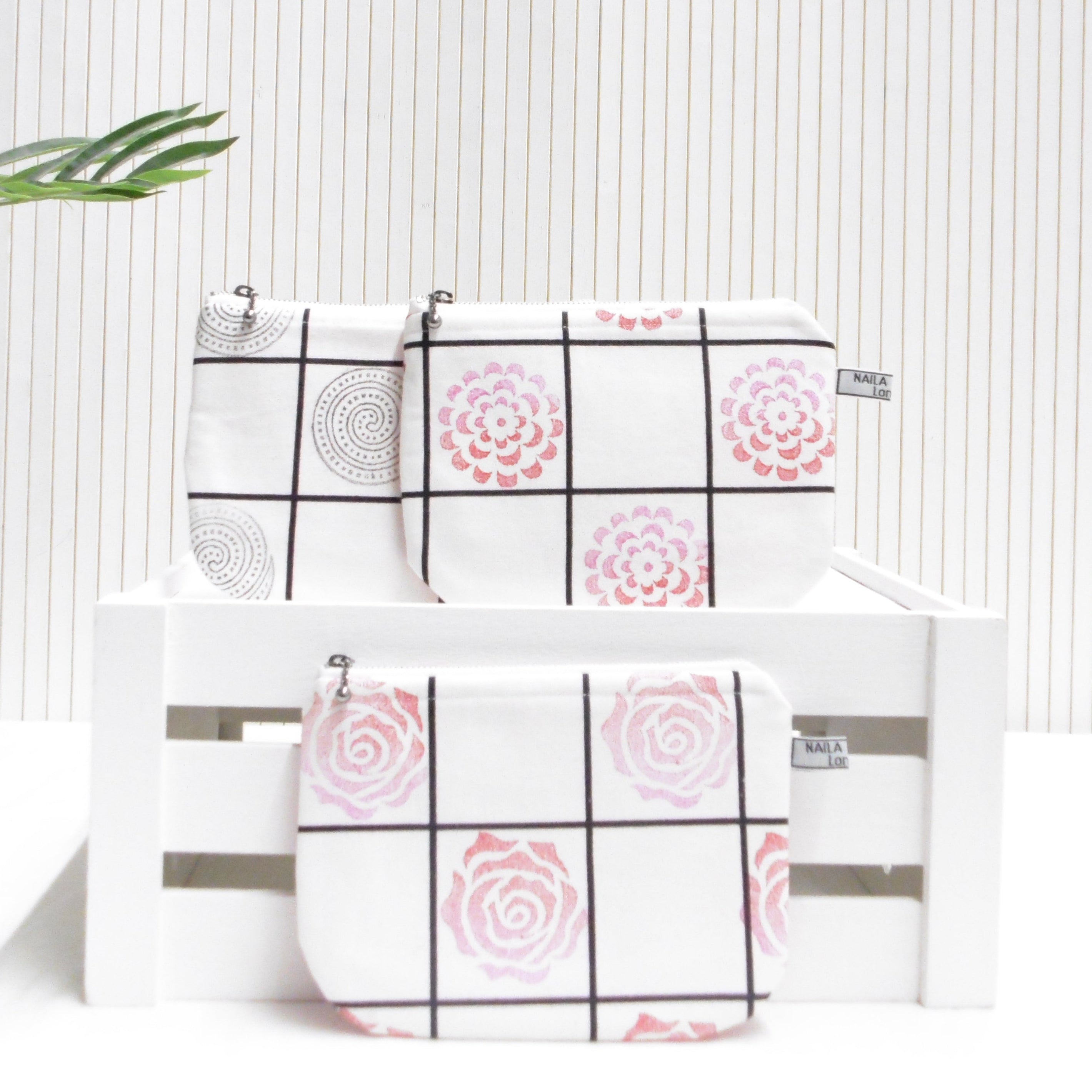 Two pouches with geometric patterns on a white background