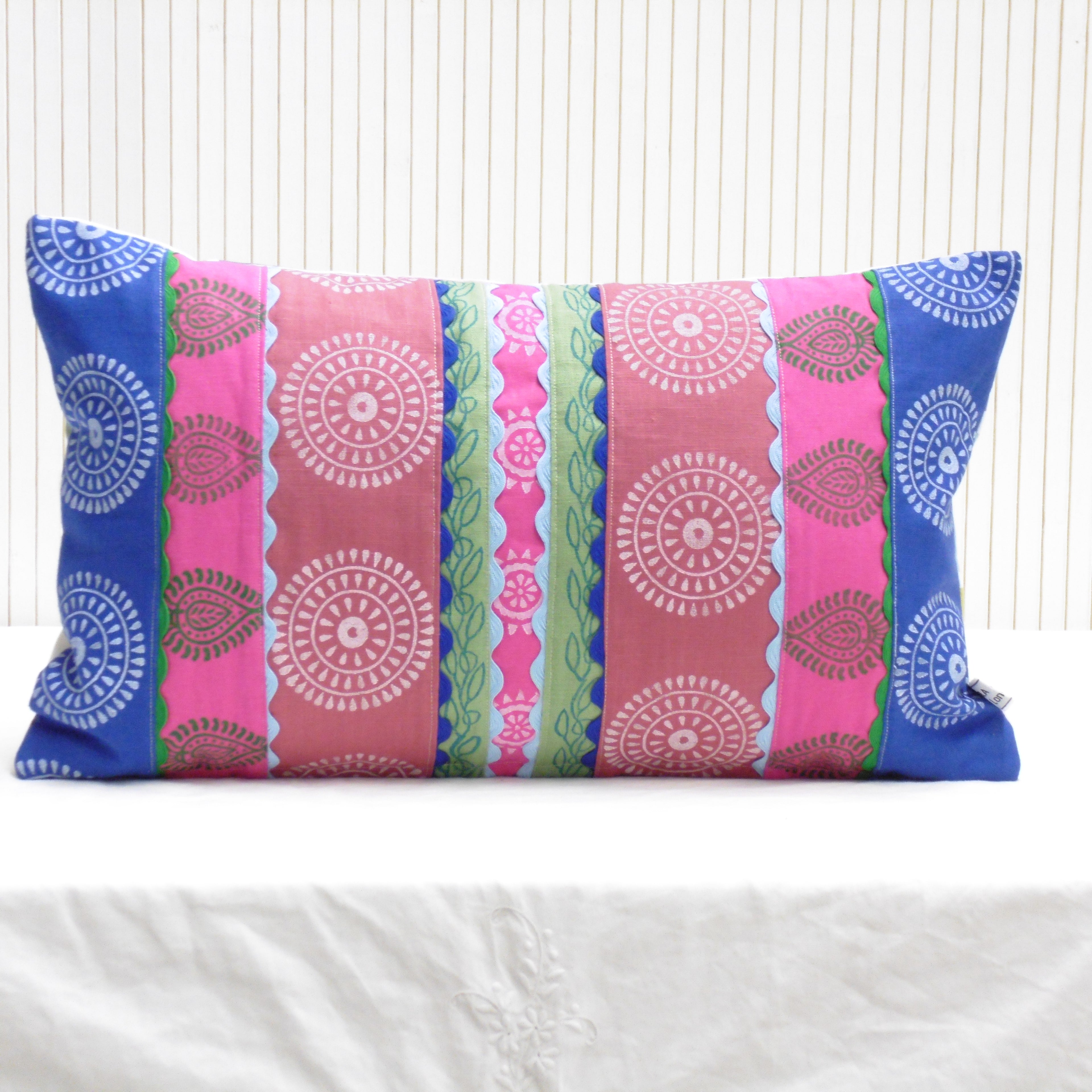 Colorful patterned pillow on a white background