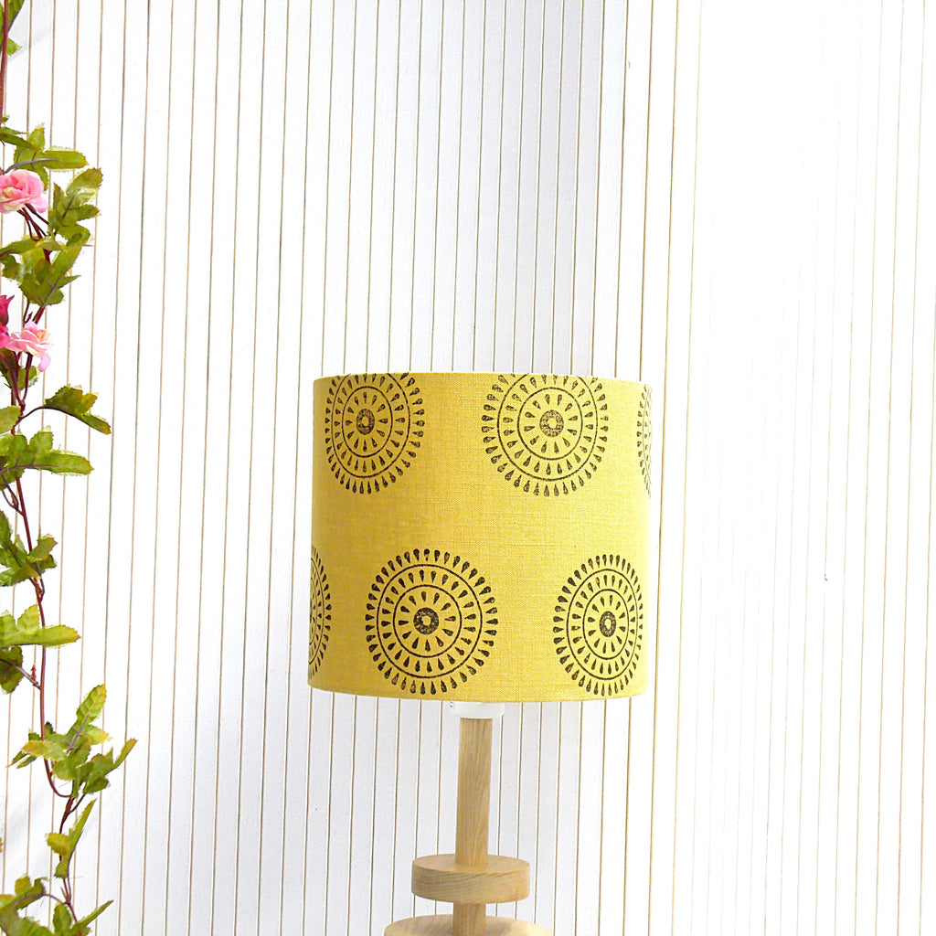 Yellow lampshade with black patterns on a white background