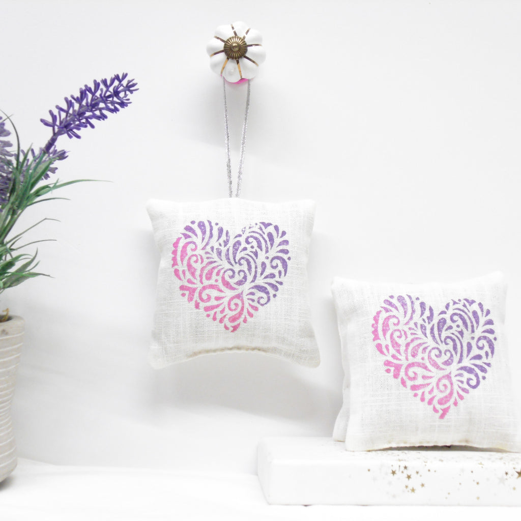 Two pillows with heart designs on a white background