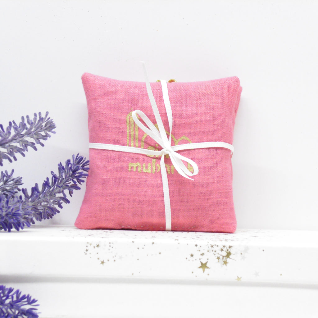 Pink fabric bundle with a white ribbon on a white background