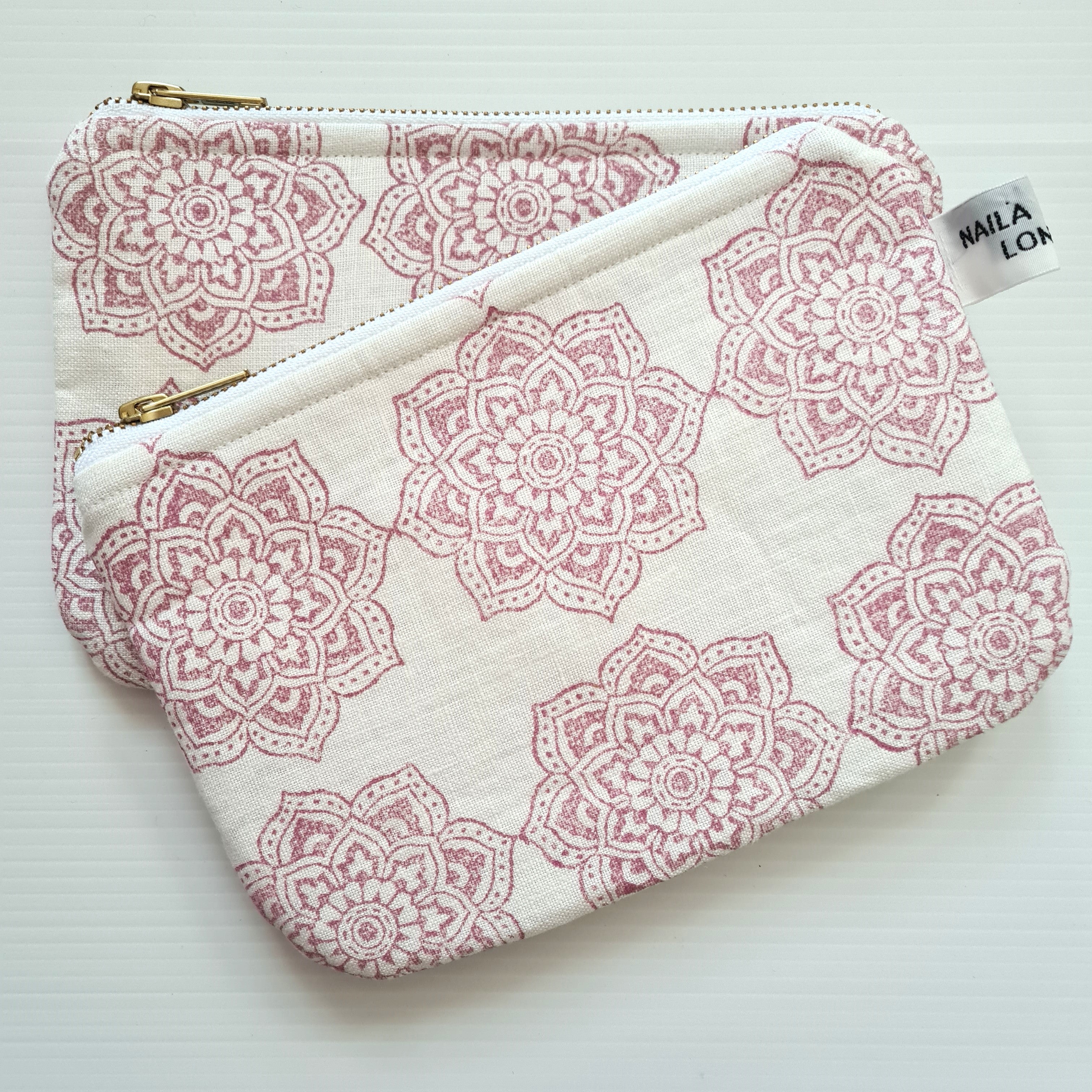 Fabric pouch with pink floral pattern on a white background