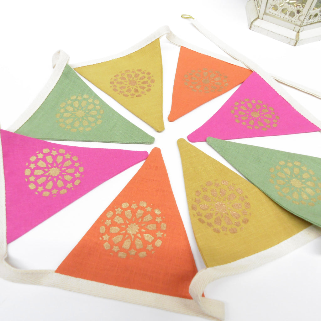 Colorful triangular flags with gold patterns on a white background