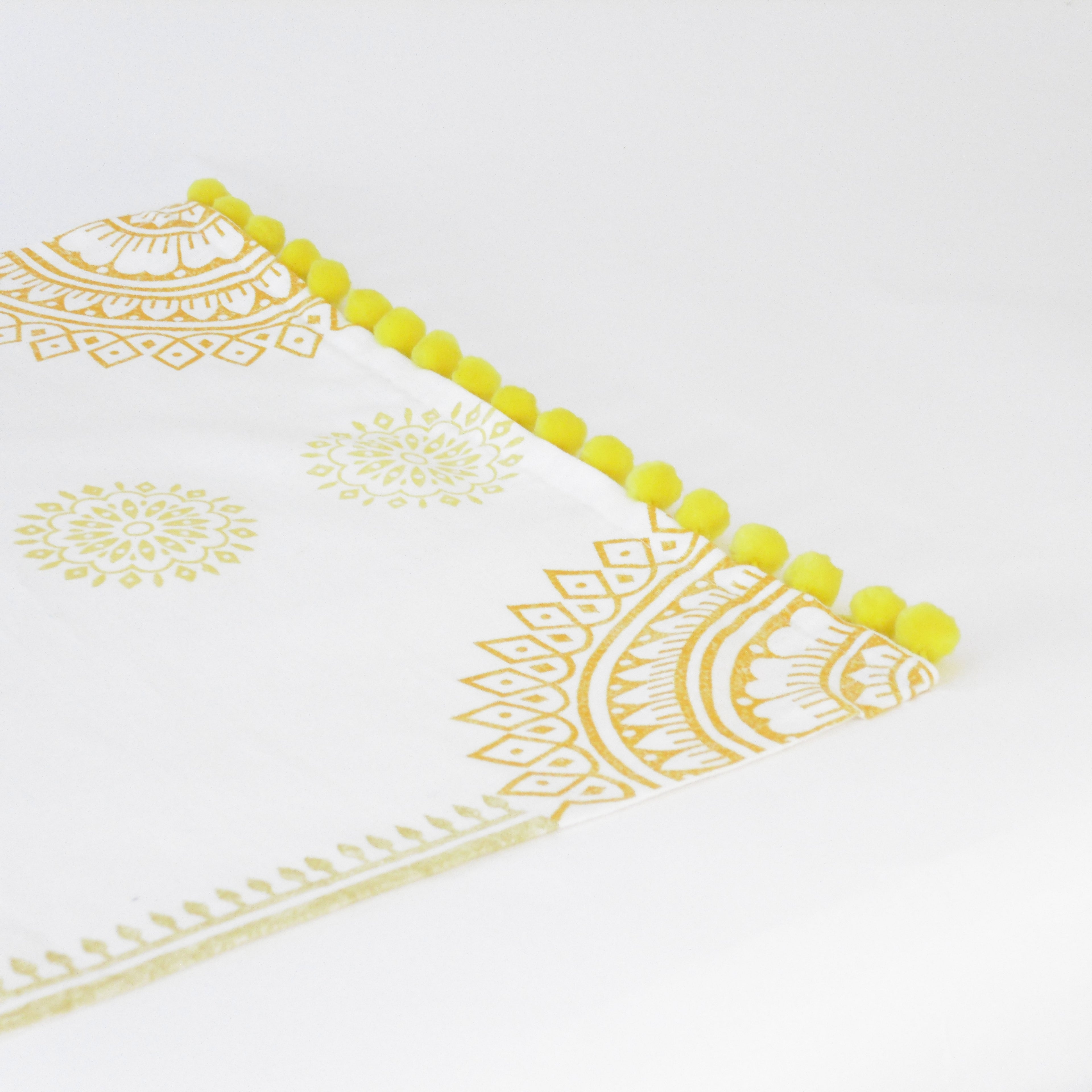 Decorative tablecloth with yellow mandala patterns on a white background